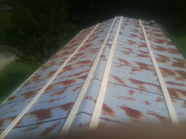 Rusted metal roof panels with new wood purlins before replacement — Storm Damage Roof Repair in Rio Vista by Roofing Brothers